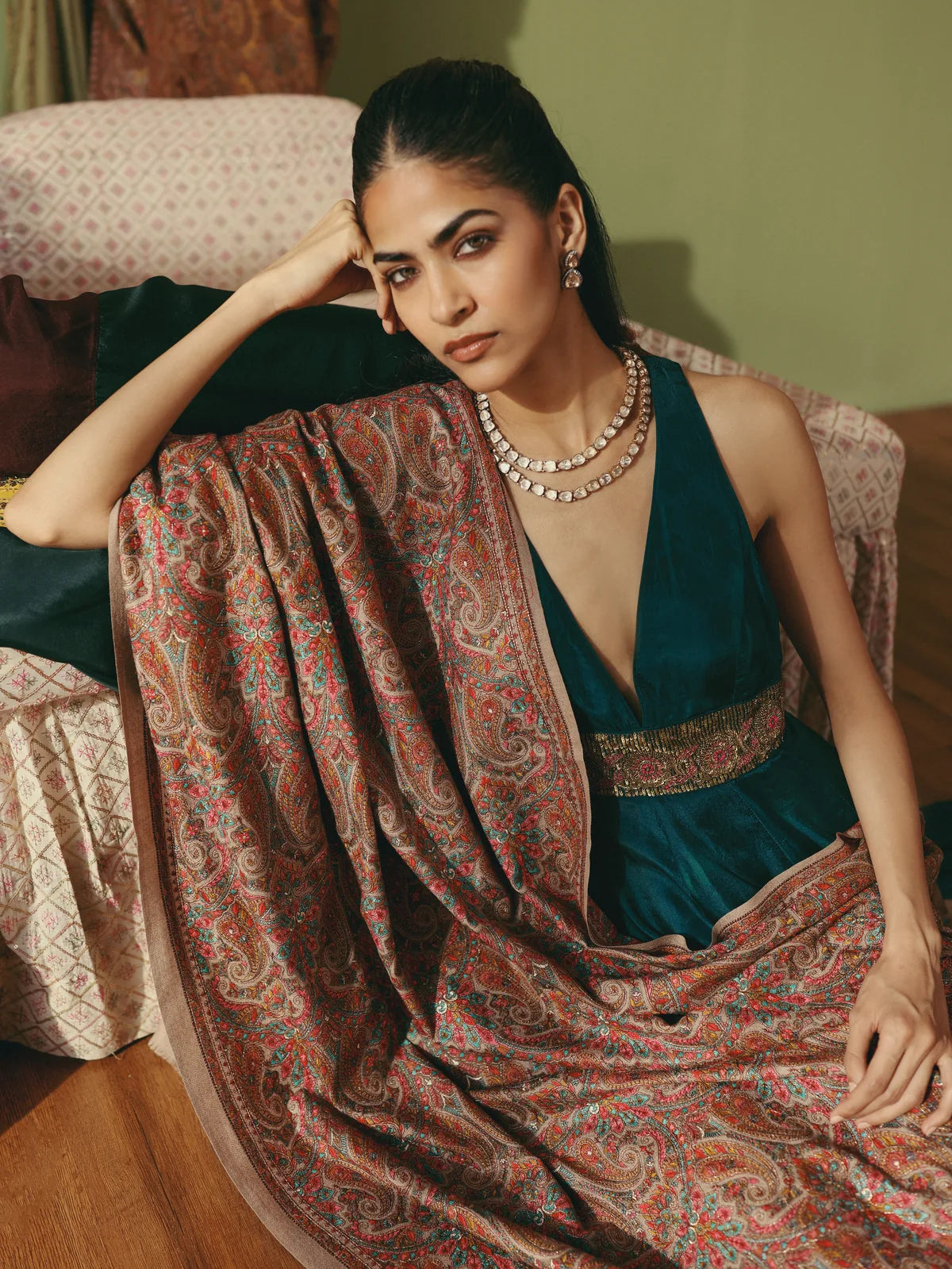 Woman in teal wearing an intricately embroidered paisley shawl